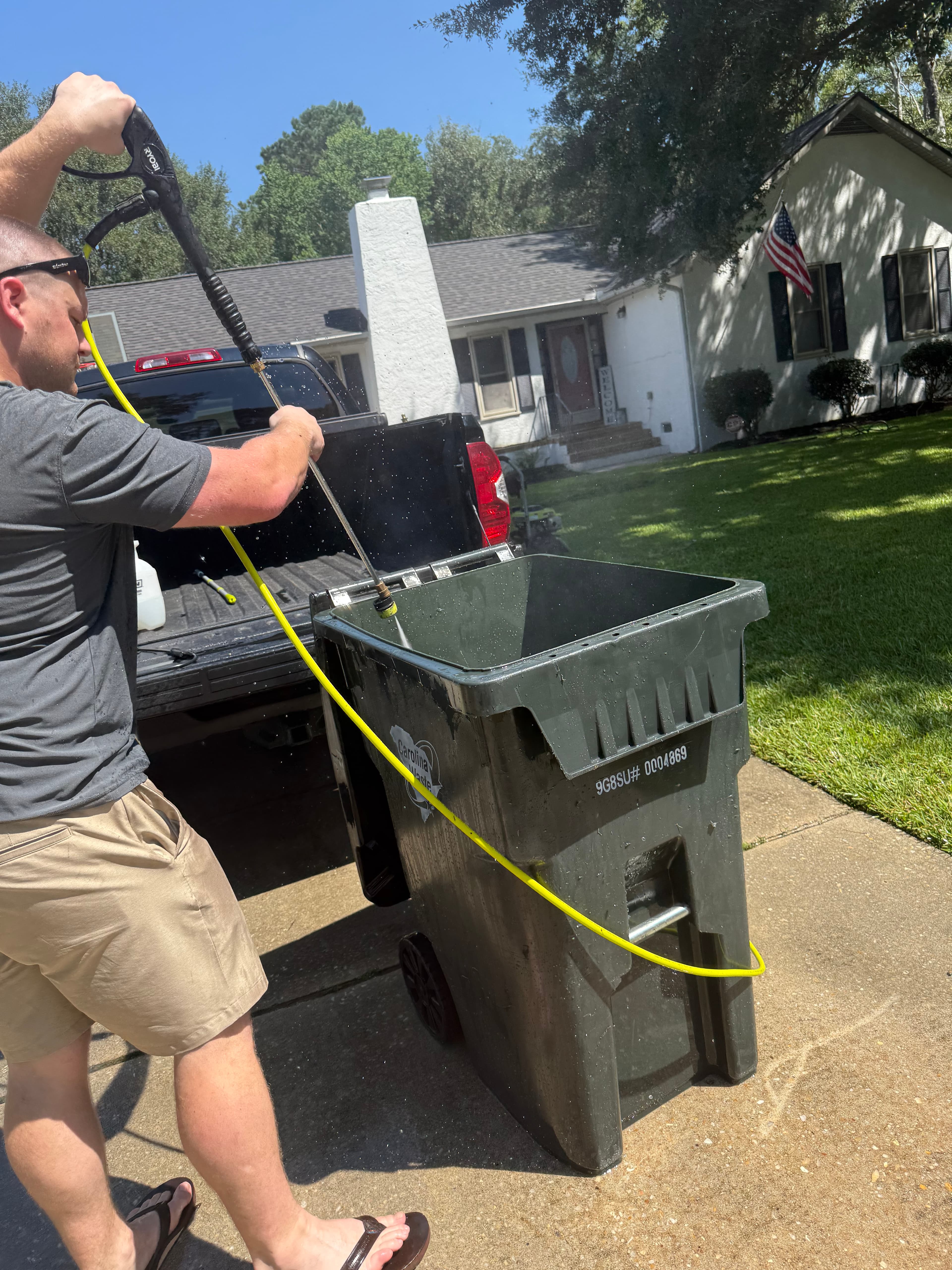 Clean Curb Co. cleaning a residential garbage bin during service.